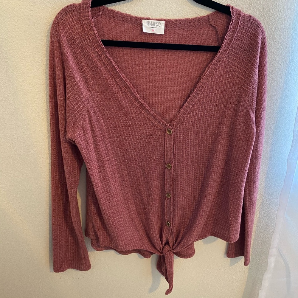 Pink button down sweater and front tie knot